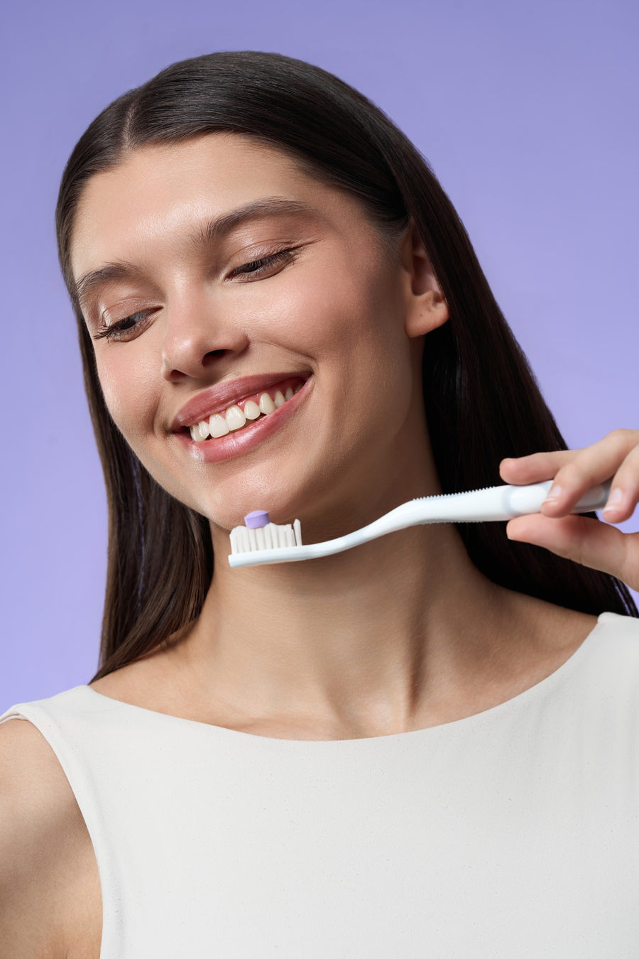DR.DENT Purple Toothpaste Tablet next to a toothbrush
